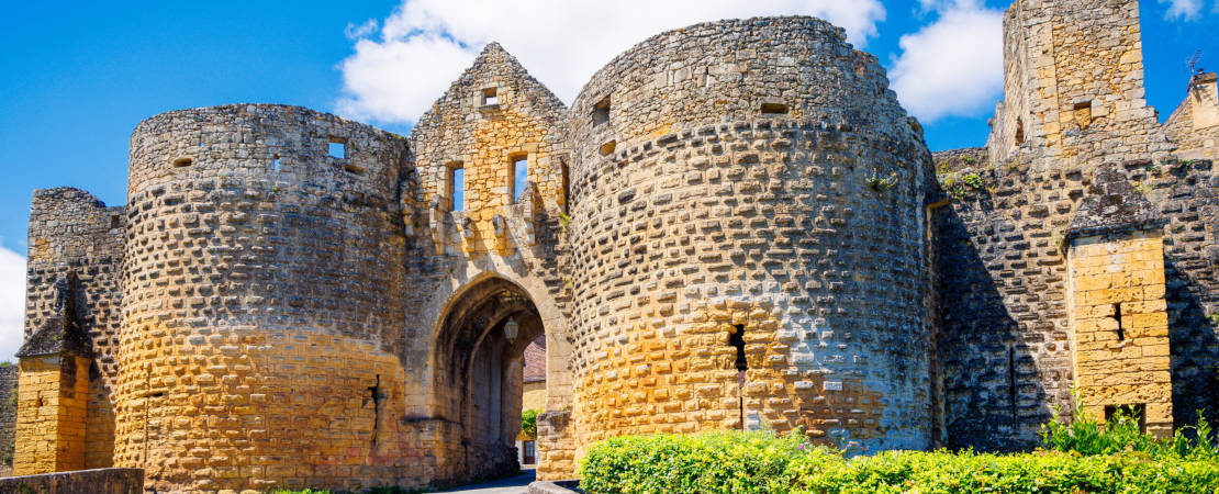 Entrance door in the wall of famous historic town of Domme- Dordogne, Perigord in France